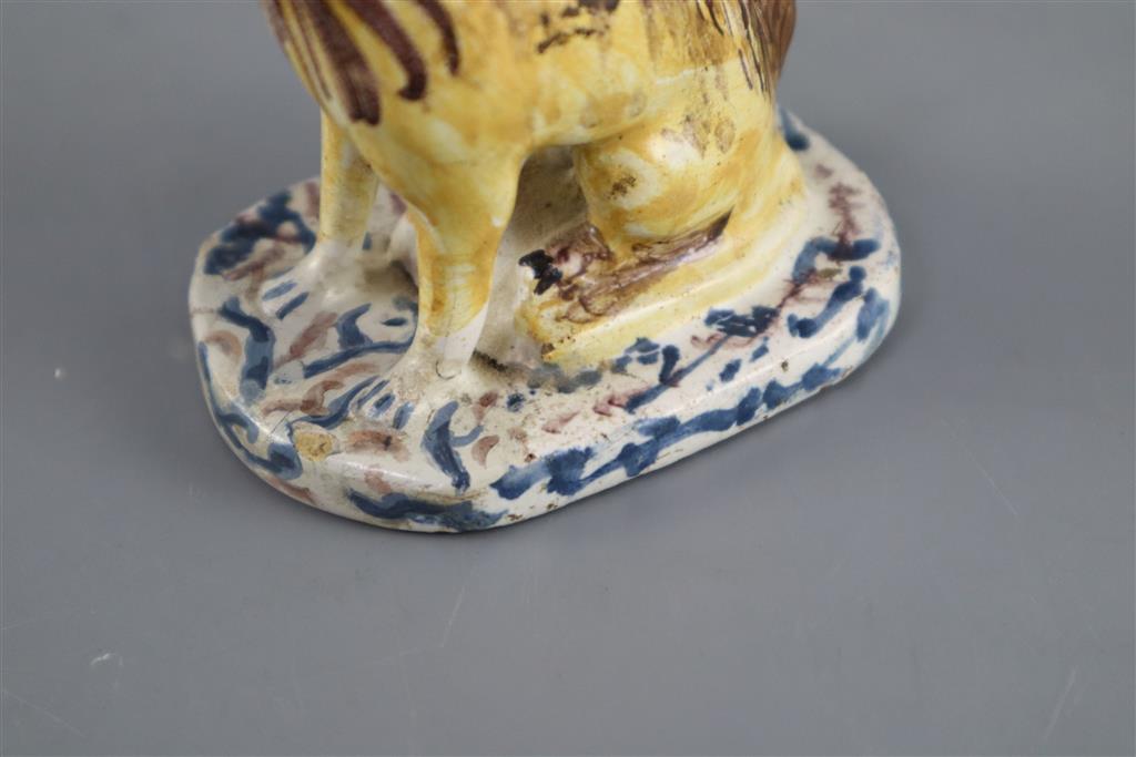 A Continental faience model of a seated dog, mid 18th century, possibly Brussels,